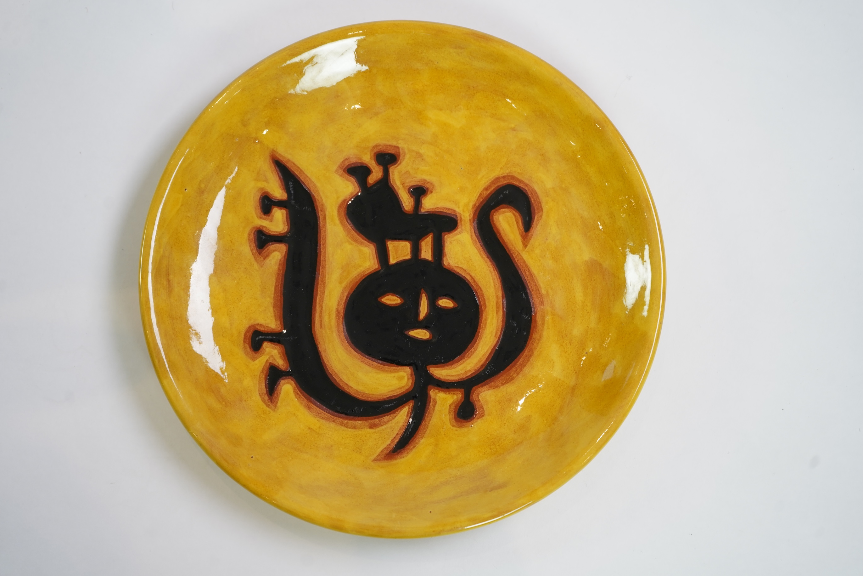 Jean Lurçat (1892-1966): A yellow glazed earthenware plate, decorated with a stylised central figure